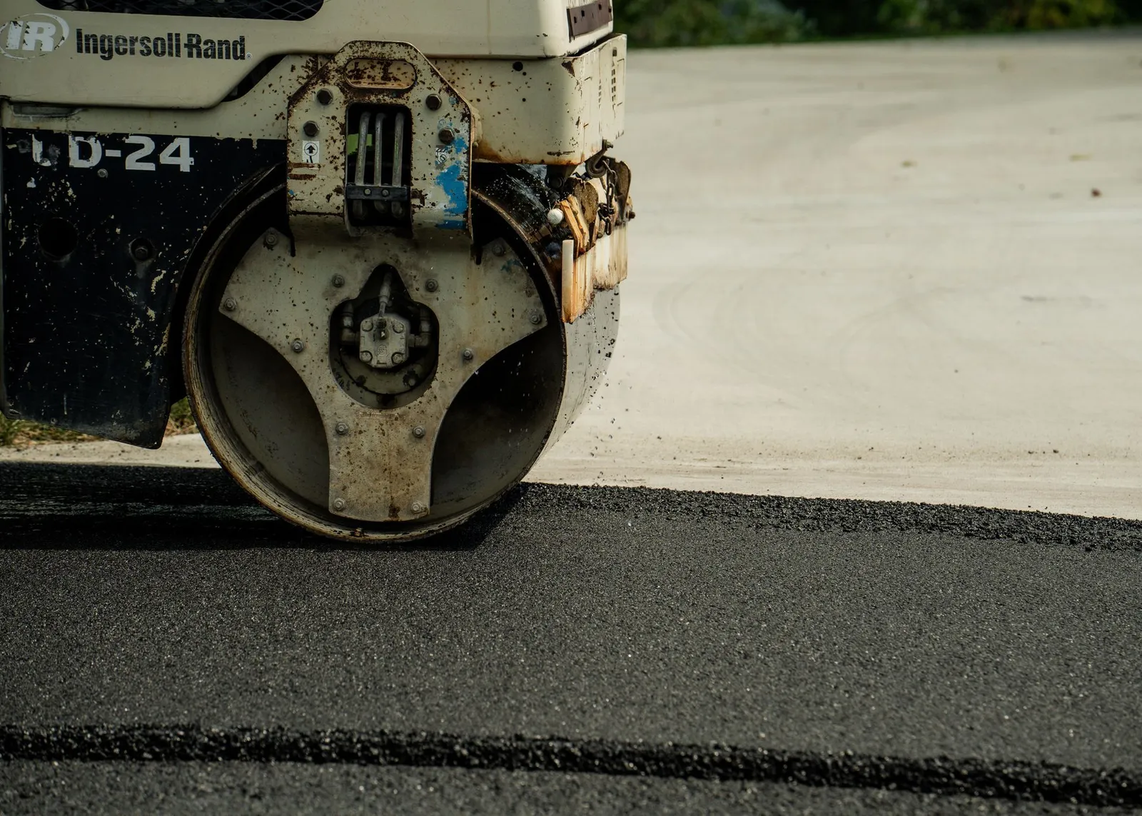 Asphalt roller compacting a fresh surface