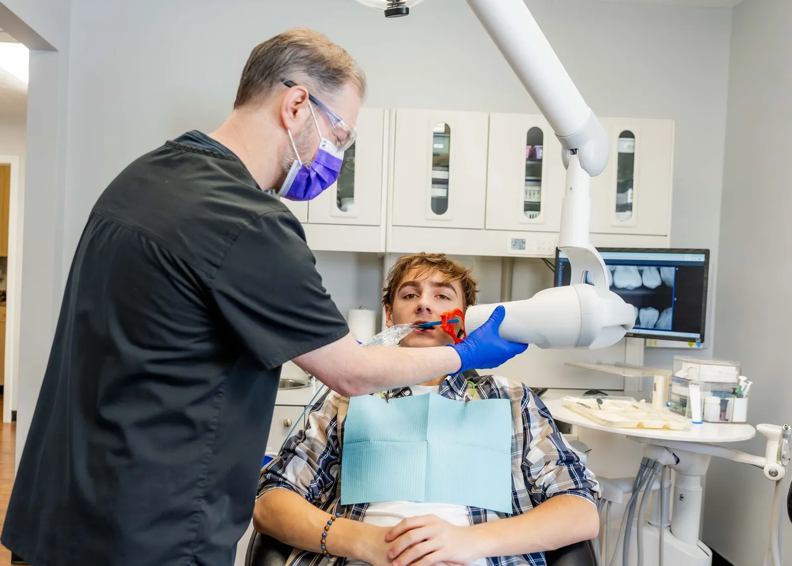 Dentist taking an x-ray of a young patient