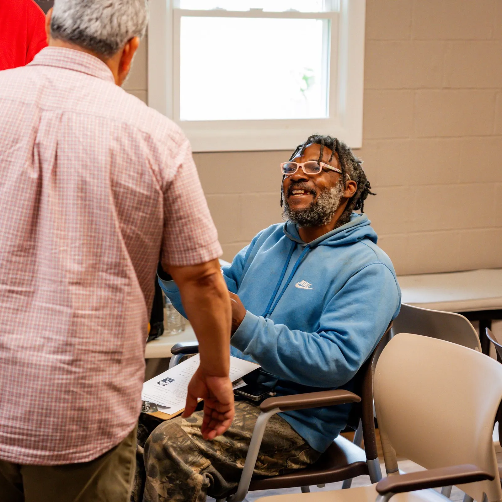 A man laughing during a conversation at Lexington Rescue Mission