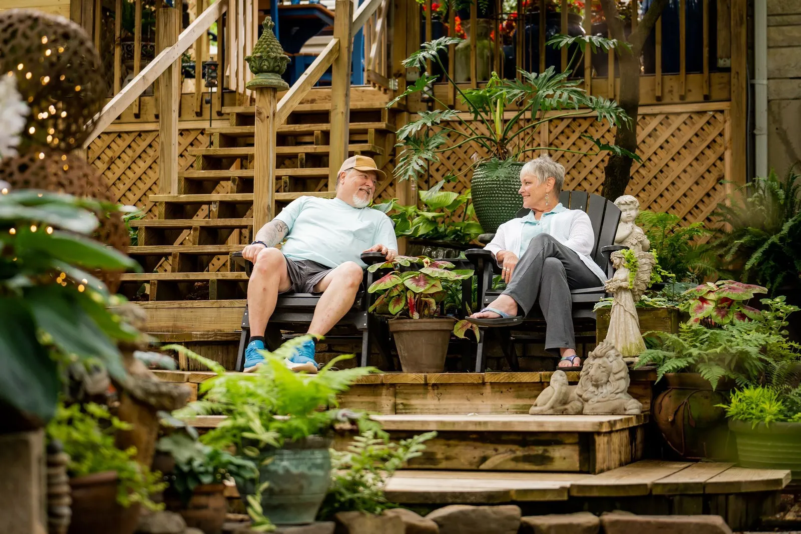 A couple relaxing on their garden deck surrounded by plants