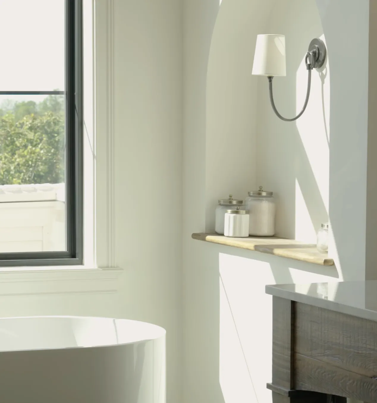 A bright remodeled bathroom with a window and open shelving