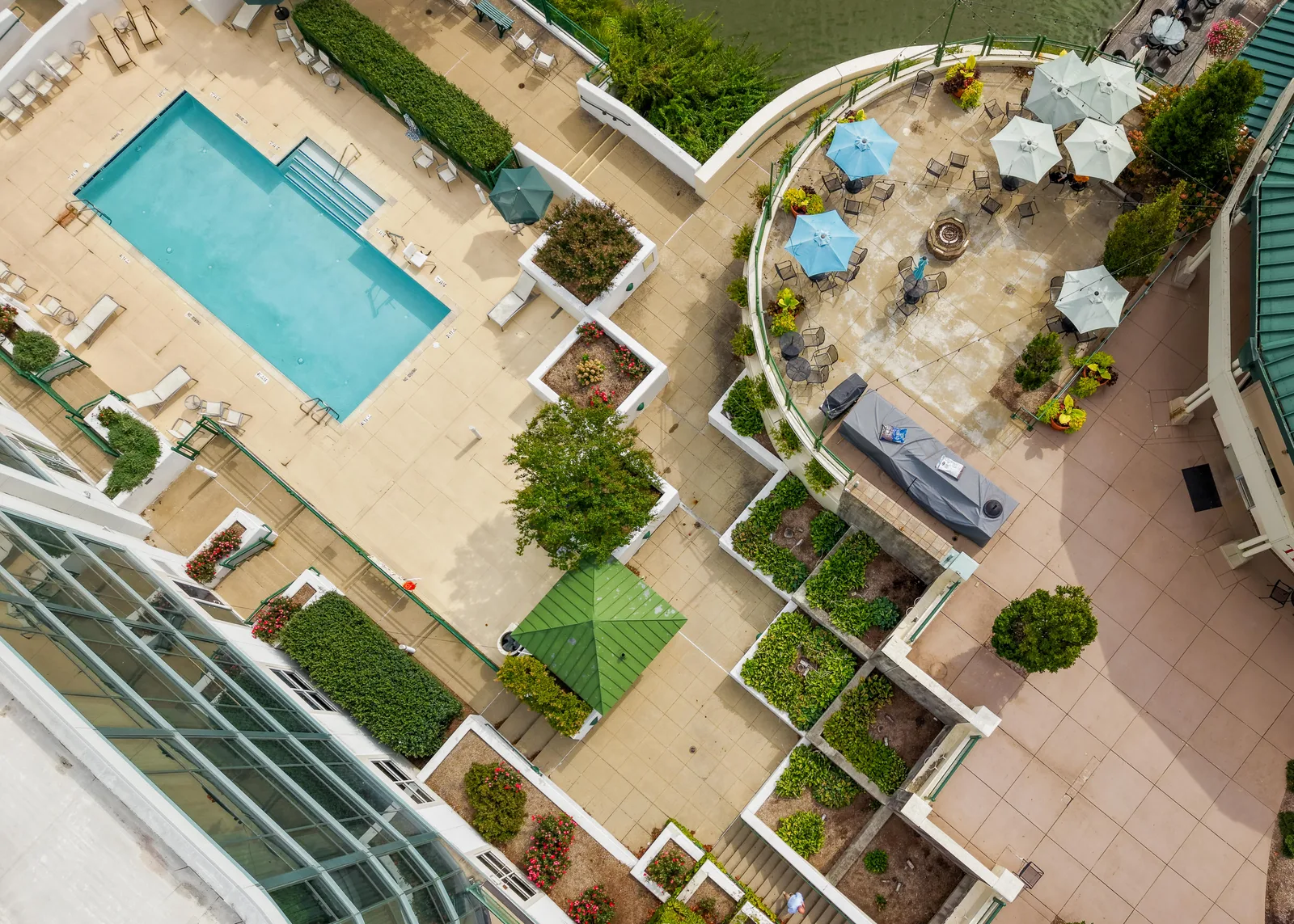 Overhead drone view of a landscaped rooftop pool terrace