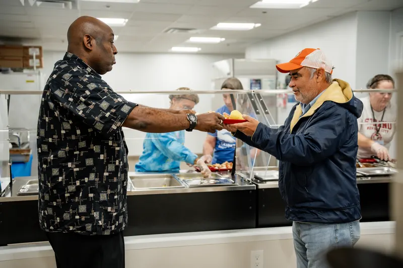 Lexington Rescue Mission volunteer serving a meal